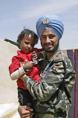 United Nations Peacekeeper Pictured with Local Child
