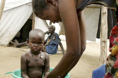 An IDP Woman Bathes Child