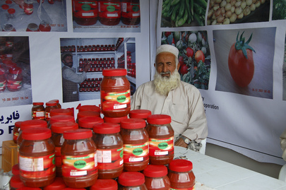 Farmer Displays Goods at Agricultural Trade Fair