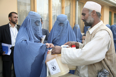 Woman Receives Cooking Oil Ration