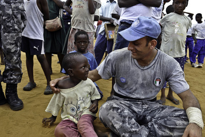 UNMIL Peacekeeper Speaks with Young Child 